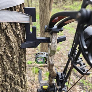 Tree stand bow hanger