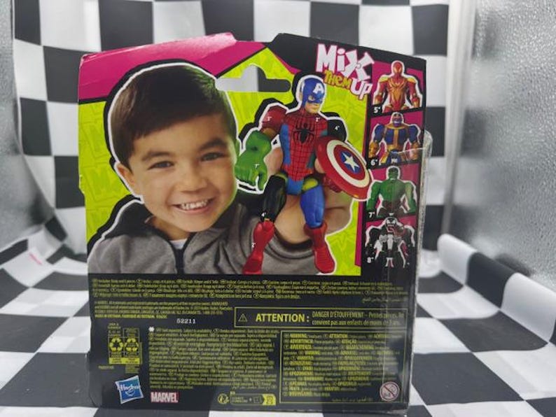 May include: Action figure packaging featuring a smiling child and a superhero toy. The toy is a combination of Captain America, Spider-Man, and Hulk. The packaging has the words "Mix 'em Up" and other superhero figures.