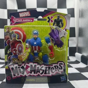 May include: A Captain America action figure from the Marvel Mix Mashers series, packaged in a green and black box. The figure is blue, red, and white, with a shield and a star on the chest. The packaging includes the Marvel logo and the words "Mix Mashers".