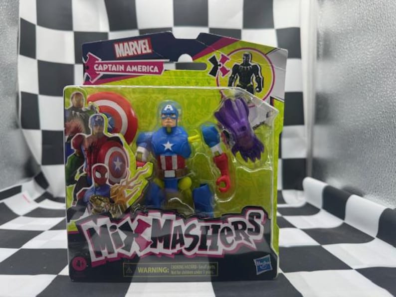 May include: A Captain America action figure from the Marvel Mix Mashers series, packaged in a green and black box. The figure is blue, red, and white, with a shield and a star on the chest. The packaging includes the Marvel logo and the words "Mix Mashers".