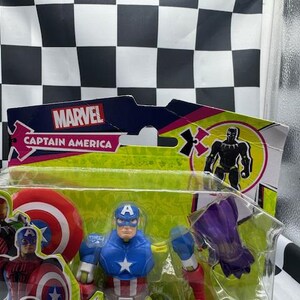 May include: A Captain America action figure in a clear plastic package. The figure is wearing a blue and red costume with a white star on the chest and a blue helmet with a white "A". The packaging features the Marvel logo.