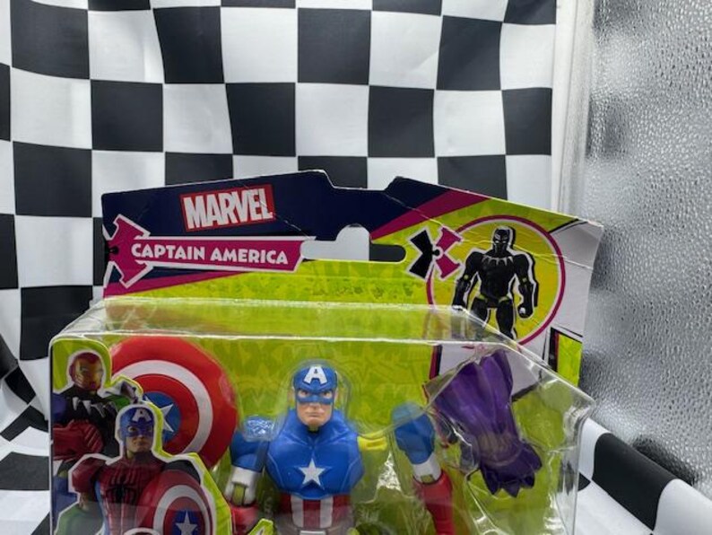 May include: A Captain America action figure in a clear plastic package. The figure is wearing a blue and red costume with a white star on the chest and a blue helmet with a white "A". The packaging features the Marvel logo.
