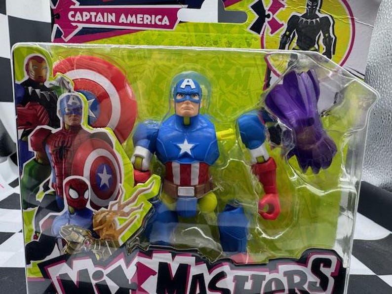 May include: A Captain America action figure in a plastic package. The figure is blue, red, and white, with a star on the chest and a shield. The packaging includes other Marvel characters and the words "Mix Mashers".