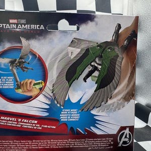 May include: Marvel's Falcon action figure from Captain America: Brave New World. The packaging features a graphic of the Falcon in flight, with green and gray wings. The packaging also includes text in multiple languages.
