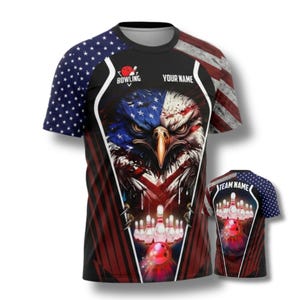 May include: A black bowling t-shirt featuring a patriotic design with an American flag and an eagle. The shirt includes the text "BOWLING" and space for "YOUR NAME" and "TEAM NAME". The design incorporates red, white, and blue colors.