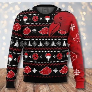 May include: Black crew neck sweater with a red raven graphic on the right shoulder. The sweater features a repeating pattern of red clouds, white snowflakes, and anime-inspired symbols. The left sleeve is red with white cloud and snowflake designs.