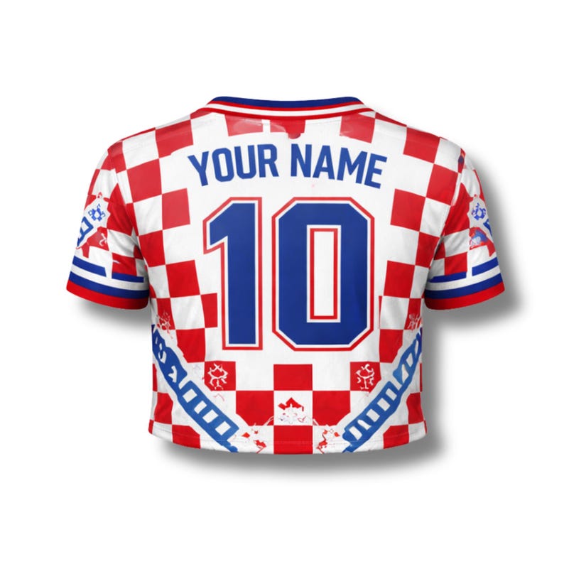 May include: Cropped soccer jersey with a red and white checkered pattern. The jersey features the number 10 in blue, with the text "YOUR NAME" above it. The sleeves have blue and white stripes.