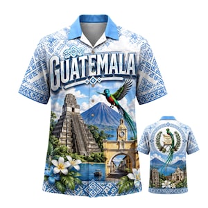 May include: A short-sleeved button-down shirt featuring a vibrant Guatemalan landscape design. The shirt showcases the word "Guatemala" in large letters, along with images of a pyramid, a volcano, and a colorful bird. The shirt has a light blue collar and cuffs.