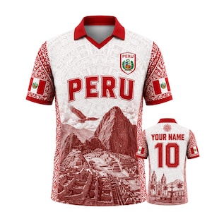 May include: A white and red polo shirt featuring a graphic of Machu Picchu, a flying eagle, and the text PERU. The front displays the Peruvian coat of arms. The back shows the text YOUR NAME above the number 10, with a building illustration below.