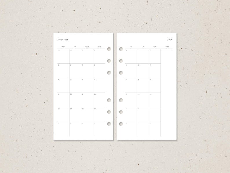 May include: Two-page spread of a minimalist planner insert. The left page is labeled "JANUARY" and displays a monthly calendar grid. The right page is labeled "2026" and also shows a monthly calendar grid. Both pages are white with black grid lines.