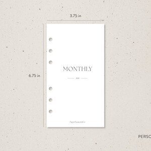 May include: A white planner insert labeled "MONTHLY" with the year "2024". The insert is 3.75 inches wide and 6.75 inches tall, with pre-punched holes for a personal size planner.