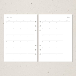 Puede incluir: Una p&aacute;gina doble de planificador minimalista para enero y 2026. La p&aacute;gina izquierda muestra una cuadr&iacute;cula de calendario mensual con los d&iacute;as de la semana en la parte superior. La p&aacute;gina derecha muestra la cuadr&iacute;cula del calendario con espacio para notas.