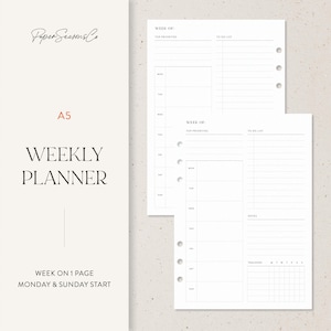 May include: A5 weekly planner with a minimalist design. The cover features the text "WEEKLY PLANNER" and "Paper Seasons Co" in a serif font. The planner includes a week-on-one-page layout with sections for top priorities and a to-do list.