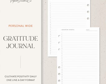 May include: A white gratitude journal with lined pages and a three-hole punch design. The cover features the text "GRATITUDE JOURNAL" and "PERSONAL WIDE" in a minimalist font. The journal is designed for daily one-line entries.