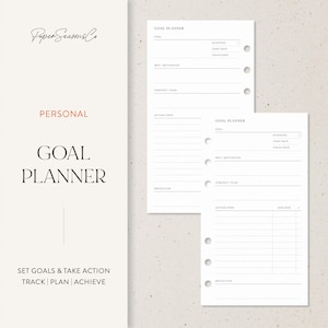 May include: A white personal goal planner with the text "GOAL PLANNER" and "SET GOALS & TAKE ACTION TRACK | PLAN | ACHIEVE". The planner includes sections for goals, action steps, and reflection.