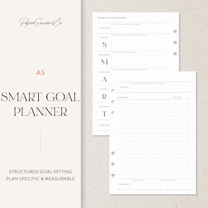 May include: A5 Smart Goal Planner with a structured goal-setting design. The planner includes sections for specific, measurable, achievable, relevant, and time-bound goals. The cover features the text "Smart Goal Planner" and "Paper Seasons Co."