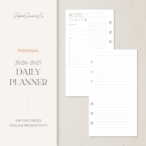 May include: A daily planner insert with a minimalist design. The planner includes sections for priorities, to-do lists, and lined pages. The text "2026-2027 DAILY PLANNER" is displayed prominently. The planner is designed for focus and productivity.