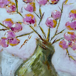 May include: An abstract painting of a green vase holding pink and yellow flowers. The flowers have a textured appearance, and the background is white with hints of pink. The vase is a muted green color.