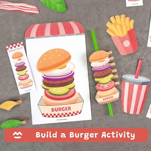 Pode incluir: Um conjunto "Build a Burger Activity" com recortes de papel de ingredientes de hambúrguer, batatas fritas e uma bebida. A imagem principal mostra um hambúrguer grande com coberturas, um cartão de receita e a palavra "BURGER".