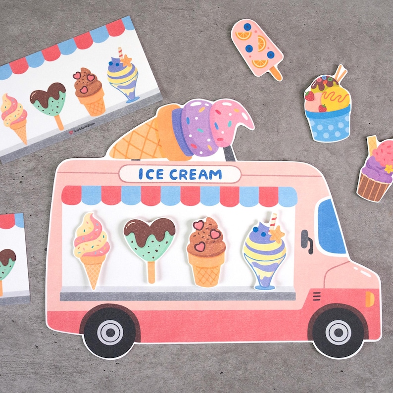 May include: A pink ice cream truck cutout with the text ICE CREAM, featuring a red and blue striped awning. The truck displays four ice cream treats: a cone, a heart-shaped popsicle, a chocolate cone, and a sundae. Additional ice cream stickers surround the truck.