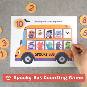 May include: A Spooky Bus Counting Game featuring an orange bus illustration with the text Spooky Bus. Ten square tiles depict Halloween characters including a pumpkin, mummy, vampire, ghost, witch, devil, zombie, cat, and Frankenstein's monster.