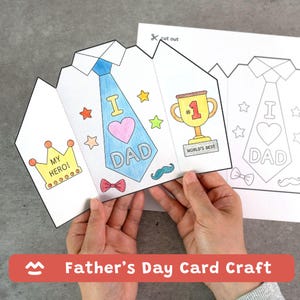 May include: A Father's Day card craft in the shape of a shirt and tie. The card features a blue tie with "I ❤️ DAD" and a trophy that says "World's Best." The card is held by hands and has a crown that says "My Hero!"