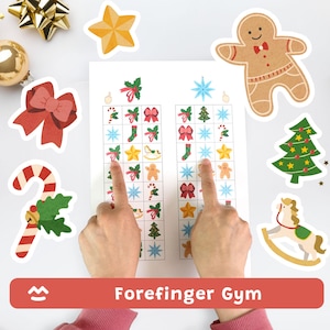 Può includere: Un gioco a tema natalizio con una griglia di icone festive, tra cui fiocchi, stelle e omini di pan di zenzero. Il gioco viene giocato con due indici che puntano alla griglia. Il testo "Forefinger Gym" è visualizzato su uno striscione rosso.