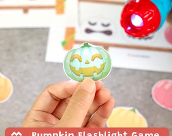 May include: A small, die-cut paper pumpkin cutout with a light green and yellow jack-o'-lantern face. A bright blue and red flashlight shines light through the cutout, revealing the pumpkin design. The game includes multiple pumpkin shapes.