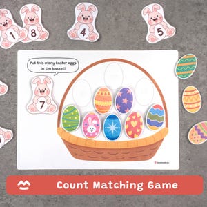 Op de afbeelding: Een telspel met een bruine mand, kleurrijke paaseieren en konijn-thema nummerkaarten. Het spel bevat een wit bord met de tekst "Put this many Easter eggs in the basket!" en de woorden "Count Matching Game".