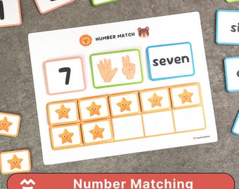 May include: A white Number Matching game board with the number 7, the word "seven", and star-shaped tiles. The board also features illustrations of hands and a lion and bear graphic. The game includes number cards.