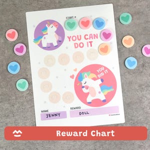 May include: A white reward chart with a unicorn theme. The chart features a unicorn illustration, the text "YOU CAN DO IT", and spaces for name and reward. Includes heart-shaped stickers in various colors. The text "Reward Chart" is at the bottom.