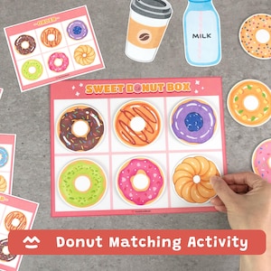 Puede incluir: Un juego de actividades de emparejamiento de donuts con ilustraciones coloridas de donuts. El conjunto incluye una caja rosa "Sweet Donut Box", tarjetas de donuts y recortes temáticos de alimentos como café y leche. Se muestra el texto "Donut Matching Activity".