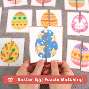 May include: A set of Easter egg puzzle matching cards. One card shows a blue egg with star designs, split in two. Other cards feature colorful egg designs with carrots, hearts, and geometric patterns. The text "Easter Egg Puzzle Matching" is displayed.