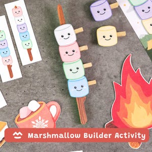 May include: A colorful illustration of a marshmallow builder activity. The image features stacks of smiling marshmallows in various colors, a mug of hot cocoa, and a campfire. The text "Marshmallow Builder Activity" is displayed.