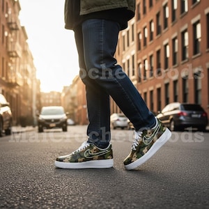 May include: Camouflage-patterned sneakers with white soles and laces. The sneakers feature a white Nike swoosh logo on the side. The shoes are worn with blue jeans. The image is taken on a city street.