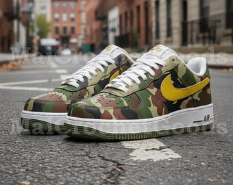 May include: A pair of camouflage-patterned sneakers with a yellow swoosh logo. The shoes have white laces, a white midsole, and a green and brown camouflage design. The sneakers are on an asphalt surface.