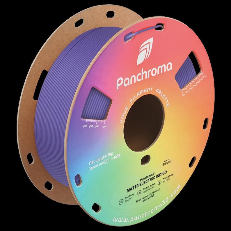 May include: A spool of Matte Electric Indigo filament for 3D printing. The spool is purple and has a cardboard core. The label features the Panchroma logo and text, with a gradient of colors. Net weight is 1kg, spool weight is 145g.