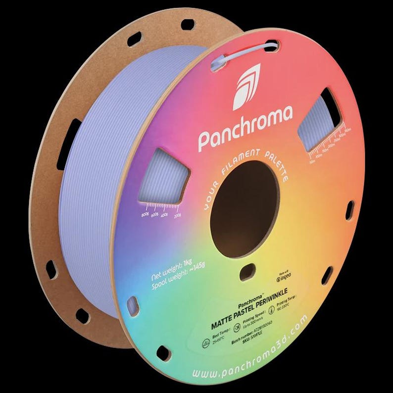 May include: A spool of matte pastel periwinkle filament for 3D printing. The spool is light blue and is on a cardboard holder with a colorful gradient label. The label includes the Panchroma logo and product information.