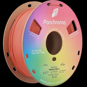May include: A spool of Panchroma Marble Brick filament, a 3D printing material. The spool is coral-colored and wrapped around a cardboard core. The label displays the brand name, filament type, and technical specifications. The net weight is 1 kg.