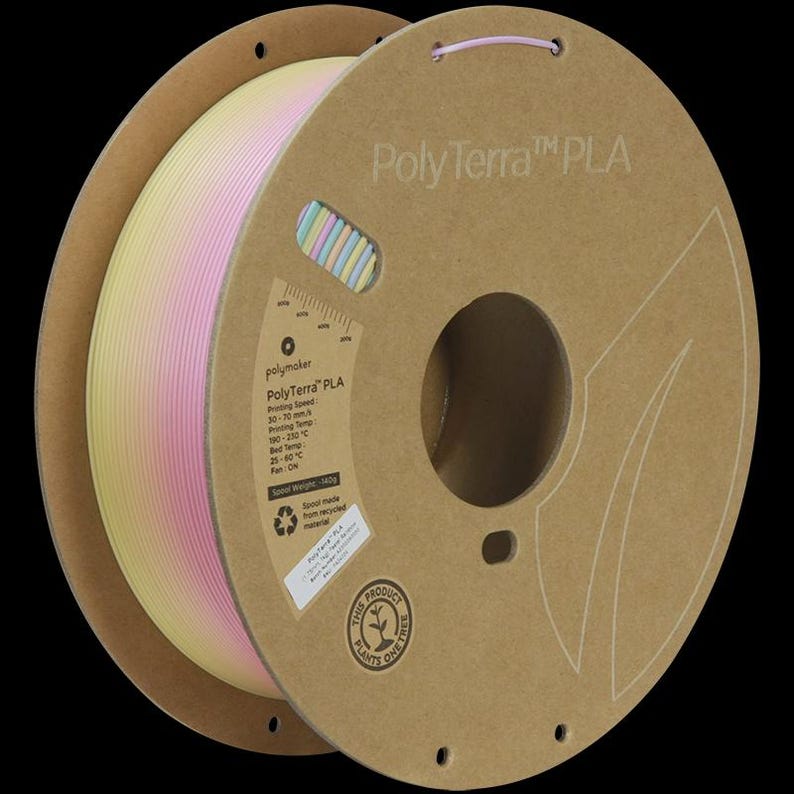 May include: A spool of PolyTerra PLA 3D printing filament. The filament is a gradient of yellow, pink, and white. The spool is made of brown cardboard and has printed text and a small window showing the filament color.