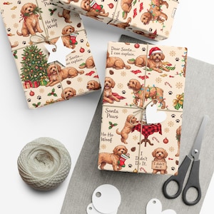 May include: Wrapping paper featuring a repeating pattern of golden-brown doodle dogs, Christmas trees, presents, and ornaments on a cream background. The text includes phrases like Dear Santa I can explain, Santa Paws, Ho Ho Woof, and I didn't do it.