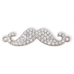 May include: A silver-toned moustache charm with clear rhinestones. The charm has a loop on each end for attaching to a necklace or bracelet.