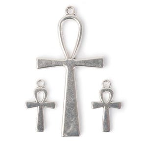 May include: Three silver Ankh charms, one large and two small. The large charm is a pendant with a loop at the top. The smaller charms are flat and have a loop at the top.