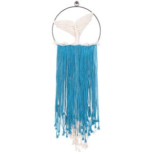 May include: A white macrame whale tail hanging from a hoop with blue and white yarn tassels.