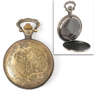 May include: A gold-toned pocket watch with an ornate floral design on the front. The watch has a hinged lid and a chain attached to the top.