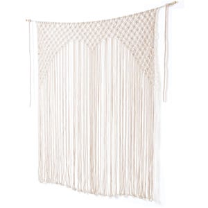 May include: A white macrame curtain with a geometric pattern and long fringe. The curtain is made of natural cotton rope and is perfect for adding a bohemian touch to any room.