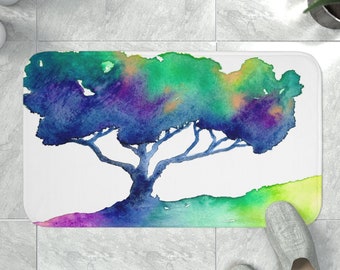 May include: A watercolor painting of a tree with blue, green, purple, and yellow hues. The tree is on a white background with a green, yellow, and purple gradient at the bottom.