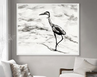 May include: Black and white watercolor painting of a heron standing on a beach. The heron is facing to the left and has its head tilted down. The background is a light gray with some darker gray clouds.