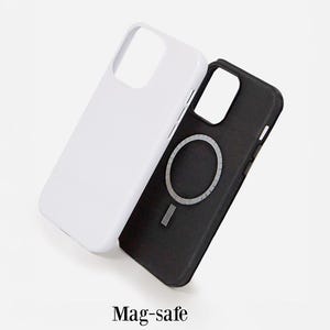 Two phone cases, one white and one black, with a magnetic feature on the black case.