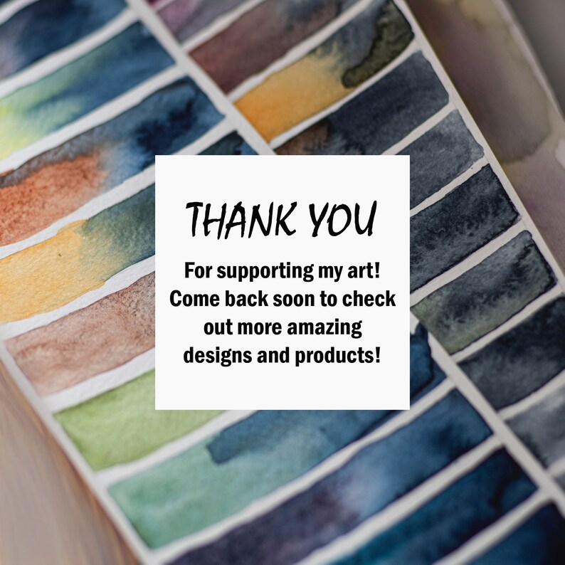 May include: A white card with the text "THANK YOU" in black lettering. The text below reads "For supporting my art! Come back soon to check out more amazing designs and products!" The card is placed on top of a watercolor paint palette with rows of colorful paint swatches.